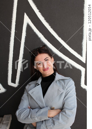 young pretty brunette woman posing emotional outside on neutral background 120512054