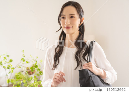 屋内でバッグを肩にかける女性 120512662