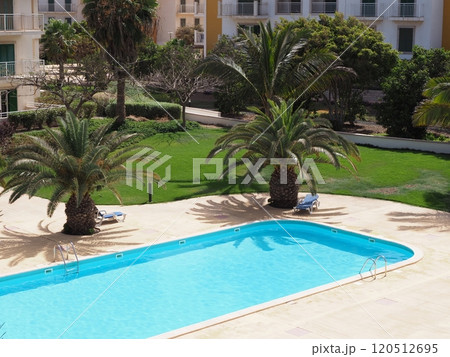 Swimming pool and palm trees in Santa Maria town at Sal island in Cape Verde 120512695