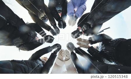 Young schoolgirls in gloves posing for a winter outdoor photo shoot in a circle 120515348