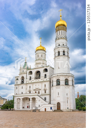 Ivan the Great Bell Tower, with Assumption Belfry on the right in Moscow Kremlin. Blue sky background with sunbeams Ivan the Great Bell Tower, with Assumption Belfry on the right in Moscow Kremlin. Blue sky background with sunbeams 120517334