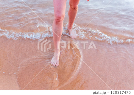 Beach - women's foot and the grains of sand. 120517470