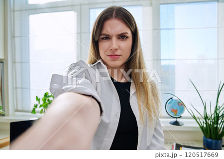 Close-up selfie portrait of teenage confused female looking at web camera Close-up selfie portrait of teenage confused female looking at web camera 120517669