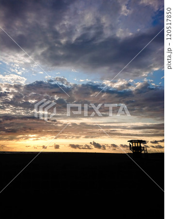 lifeguard watchtower on the seashore at sunset with beautiful clouds and sky lifeguard watchtower on the seashore at sunset with beautiful clouds and sky 120517850