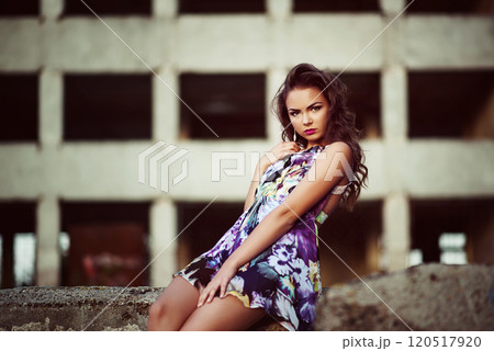 Portrait of a beautiful model posing in evening light measure concrete wall Portrait of a beautiful model posing in evening light measure concrete wall 120517920