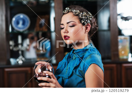 young brown-haired girl is drinking and tasting a glass red dry wine young brown-haired girl is drinking and tasting a glass red dry wine 120519279