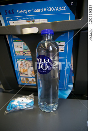 Above the Clouds, November 24, 2018: Airplane Economy Class with Water Bottle, Headphones, and A330 Safety Card Above the Clouds, November 24, 2018: Airplane Economy Class with Water Bottle, Headphones, and A330 Safety Card 120519338