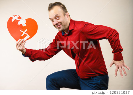 Adult man holding broken heart running 120521037