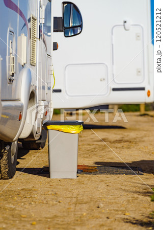 Trash can in front of caravan 120521212