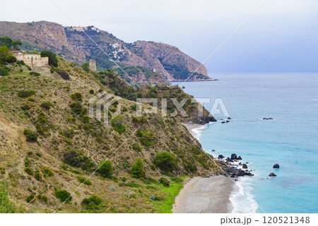 Tower on rocky coast, seaside cliffs, Spain 120521348