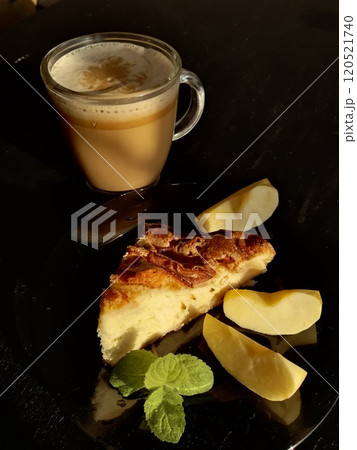Сup of coffee tea on the table with a homemade cake decorated with a fresh mint Сup of coffee tea on the table with a homemade cake decorated with a fresh mint 120521740