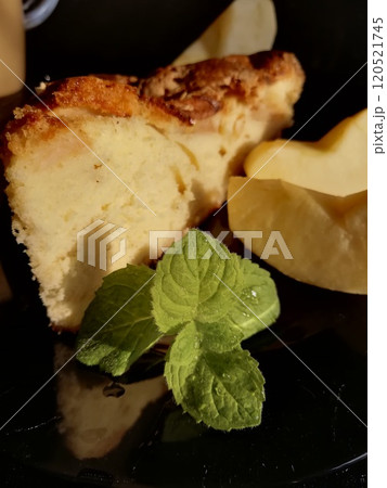 Сup of coffee tea on the table with a homemade cake decorated with a fresh mint Сup of coffee tea on the table with a homemade cake decorated with a fresh mint 120521745