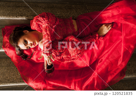 Portrait of attractive, dreamy, charming, curly ginger woman and tasting old expensive wine. 120521835