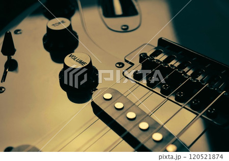 Abstract photo of an electric guitar and its parts macro photo. Music wallpaper and banner for string music album. High quality photo guitar in dark with light reflected in the lacquered surface. Abstract photo of an electric guitar and its parts macro photo. Music wallpaper and banner for string music album. High quality photo guitar in dark with light reflected in the lacquered surface. 120521874