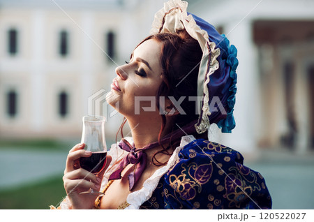 Girl drinking wine.Young woman in 18th century suit. Girl drinking wine.Young woman in 18th century suit. 120522027
