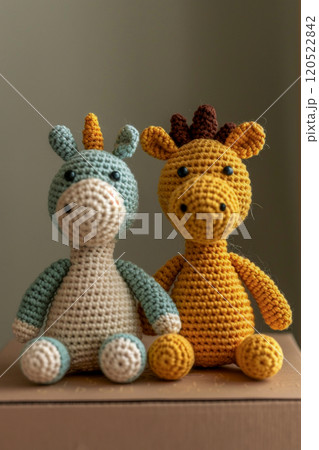 Soft cute Japanese style knitted amigurumi unicorn and giraffe sitting on a packaging box for sending to the buyer, holiday gifts Soft cute Japanese style knitted amigurumi unicorn and giraffe sitting on a packaging box for sending to the buyer, holiday gifts 120522842