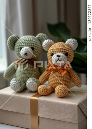 Crocheted toy bears, toys made in Japanese style amigurumi sit on a packaging box for sending to the buyer, vertical shot 120522845