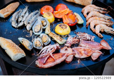 Grilled seafood and vegetables on a skillet, perfect for summer BBQ and outdoor dining inspiration Grilled seafood and vegetables on a skillet, perfect for summer BBQ and outdoor dining inspiration 120522989