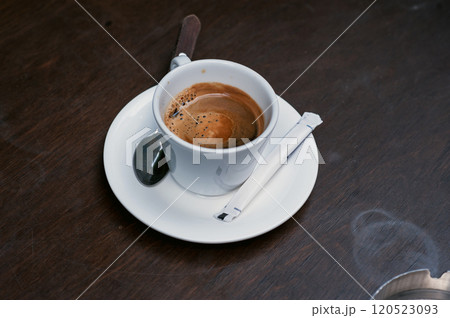 A cup of coffee on a wooden table 120523093