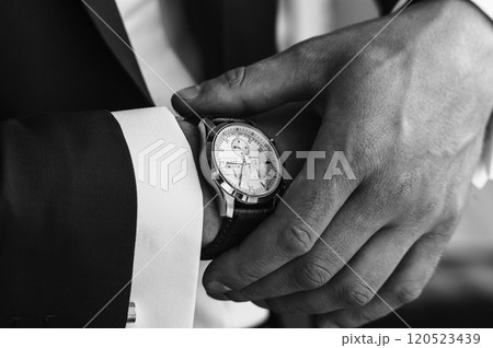 Businessman looking at the time on his wrist watch in car. Business concept. Businessman looking at the time on his wrist watch in car. Business concept. 120523439