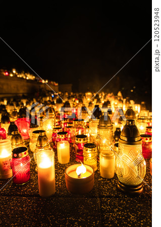 Illuminated Cemetery Candles at Night, Memorial Lanterns Honoring the Departed, All Saints Day Tribute Illuminated Cemetery Candles at Night, Memorial Lanterns Honoring the Departed, All Saints Day Tribute 120523948