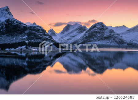 Colorful sunset sky over snowy mountains reflecting in water Colorful sunset sky over snowy mountains reflecting in water 120524593