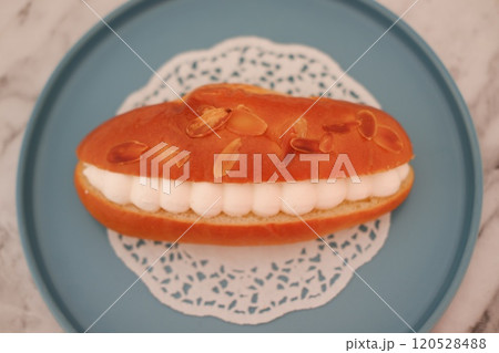 Eclair on a blue plate Eclair on a blue plate 120528488