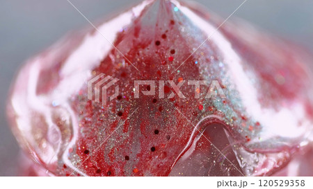 Sparkling fluid spill. Liquid shimmer texture. Blur red color shiny glitter particles paint gloss drip diamond shape abstract art background with bokeh lights. Sparkling fluid spill. Liquid shimmer texture. Blur red color shiny glitter particles paint gloss drip diamond shape abstract art background with bokeh lights. 120529358