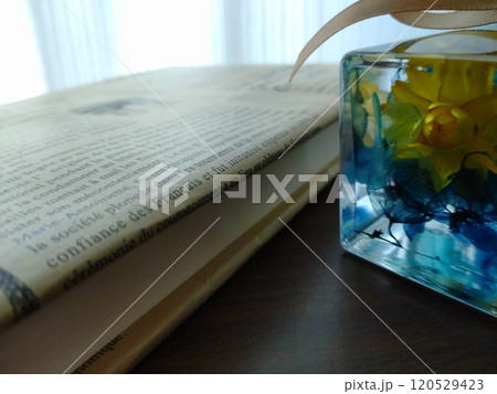 窓辺に置かれたハーバリウムと本 120529423