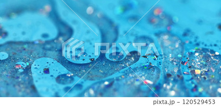 Glitter gloss mix. Acrylic paint spill. Defocused blue color shiny sequin particles gel fluid floating bubbles ink emulsion liquid drip abstract art background. Glitter gloss mix. Acrylic paint spill. Defocused blue color shiny sequin particles gel fluid floating bubbles ink emulsion liquid drip abstract art background. 120529453