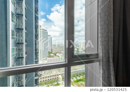 Glass windows in high-rise condos offer views of buildings. Glass windows in high-rise condos offer views of buildings. 120531425