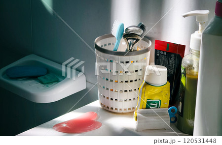The bathroom sink and the sunlight coming through the blinds 120531448