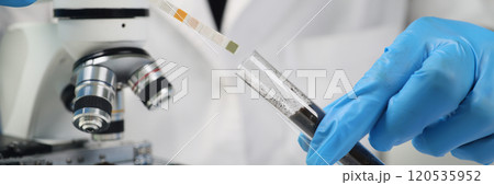 Researcher checks level of acidity of soil in glass tube Researcher checks level of acidity of soil in glass tube 120535952