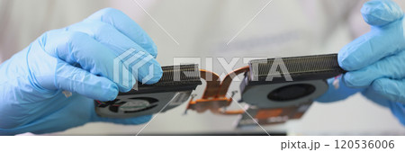 Male master in gloves holds cooling system of broken laptop Male master in gloves holds cooling system of broken laptop 120536006