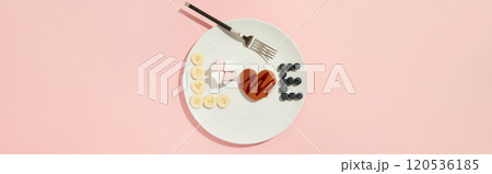 A Love symbol made of heart shaped pancake, marshmallow and fruits on the white plate with fork A Love symbol made of heart shaped pancake, marshmallow and fruits on the white plate with fork 120536185