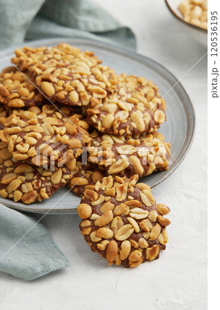 A heap of Portugues traditional peanut cookies known as Bolachas de Amendoim on the grey plate A heap of Portugues traditional peanut cookies known as Bolachas de Amendoim on the grey plate 120536195
