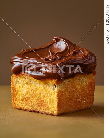 A golden slice of fluffy bread topped with rich, glossy chocolate frosting, sitting against a neutral backdrop A golden slice of fluffy bread topped with rich, glossy chocolate frosting, sitting against a neutral backdrop 120537745