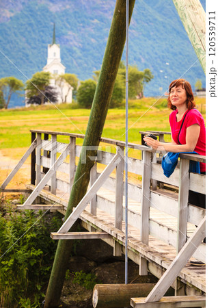 Tourist relaxing on bridge in village Oppstryn Norway 120539711