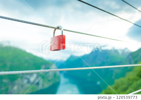 Red padlock and Geirangerfjord from Flydasjuvet viewpoint Norway Red padlock and Geirangerfjord from Flydasjuvet viewpoint Norway 120539773