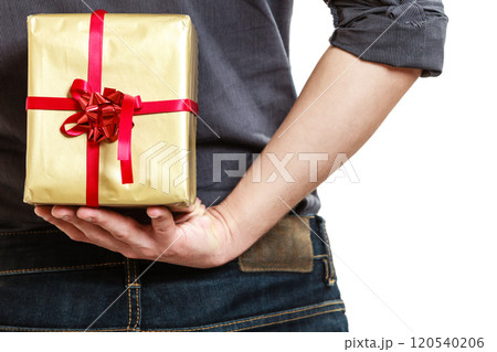 Holiday. Man hiding surprise gift box behind back 120540206