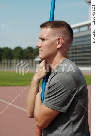 Athlete Holding Pole Vault on Outdoor Track Athlete Holding Pole Vault on Outdoor Track 120542121
