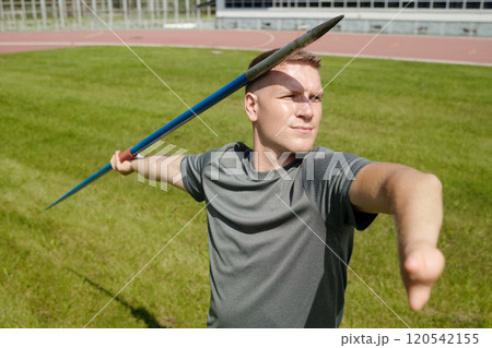 Preparing for Javelin Throw on Athletic Field 120542155