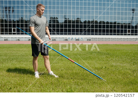Practicing Javelin Throw on Outdoor Sports Field 120542157