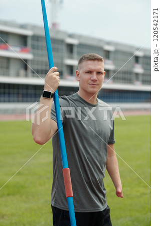 Holding Javelin in Athletic Field Setting 120542171
