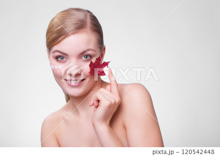 Skin care. Face of young woman girl with red maple leaf. Skin care. Face of young woman girl with red maple leaf. 120542448