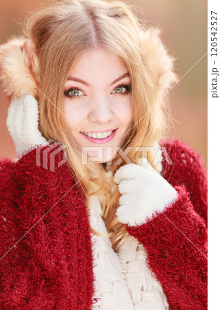 Portrait of pretty smiling woman in earmuffs. 120542527