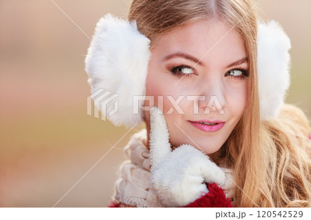 Portrait of suspicious pretty woman in earmuffs Portrait of suspicious pretty woman in earmuffs 120542529