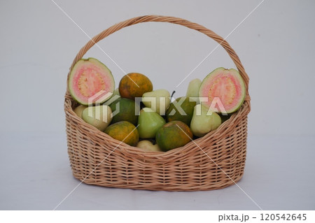 A wicker basket filled with a variety of fresh fruits 120542645