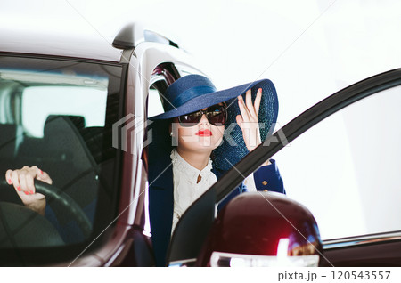 The woman  the steering wheel of the car 120543557