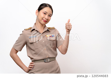 Young Thai Asian Teacher in the uniform with thumb up gesture isolated on white background. Young Thai Asian Teacher in the uniform with thumb up gesture isolated on white background. 120544083